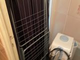 a small bathroom with a toilet and a rack in it