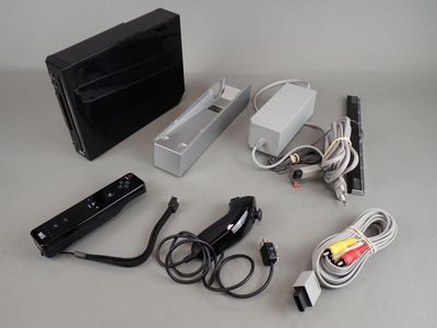 an image of a nintendo wii game system and accessories