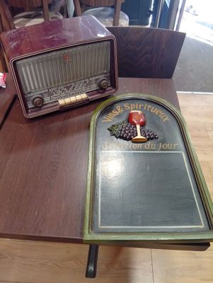 an old radio sitting on a table next to an old radio