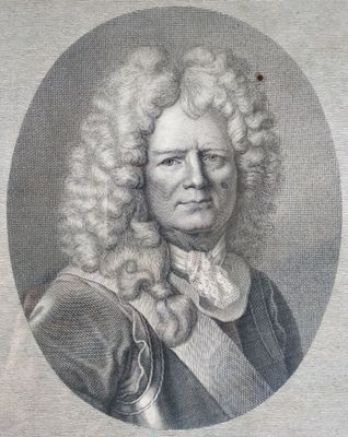 portrait of a man with long curly hair and a bow tie