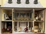a doll house with a lot of furniture inside of it