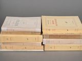 several books stacked on top of each other on a table