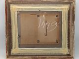an old picture frame with a picture of a person in it