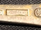 a close up of a silver spoon with a metal handle