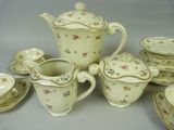 many different types of teapots and saucers on the table