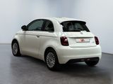the small white car is parked in a large room