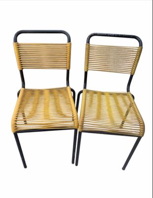 pair of vintage wicker chairs with black metal legs