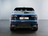 the rear end of a blue car in a white room