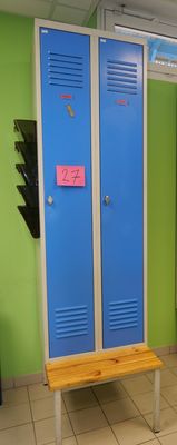 two blue lockers and a bench in a room