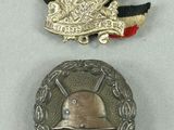 two medals and a medal on a white surface