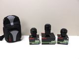 three cameras are sitting on a table next to a camera bag