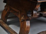a wooden table with a wooden seat and a wooden table top