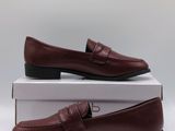 a pair of brown shoes sitting on top of a box