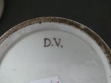 a plate with a sticker on it that says d v