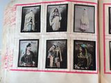 an open book with pictures of women dressed in traditional clothing