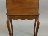an old wooden chair with a scalloped seat on a white background