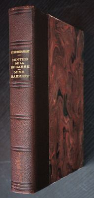 an old book sitting on top of a table next to a black background