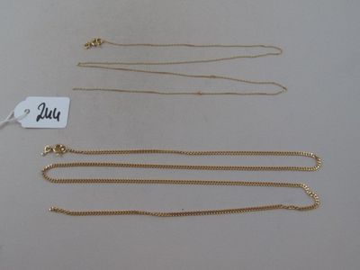 three gold necklaces and a gold chain with a price tag