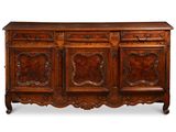 un buffet de style ancien avec des portes et des tiroirs en bois sculpté