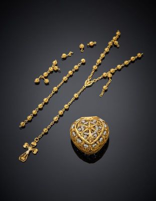 a gold and diamond necklace, bracelet, and broochle