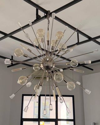 a chandelier made of forks and spoons hanging from the ceiling