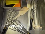 a whisk and a whisk in a container on the counter
