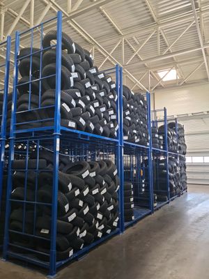 many tires stacked on a rack in a warehouse