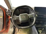 the interior of a car with a steering wheel and dashboard controls
