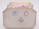 a small box with stamps on it sitting on a table