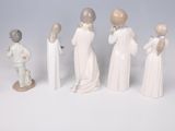 five figurines of people standing in a line
