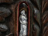 a wooden carving of a woman holding a child