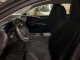 the interior of a car with black seats and a steering wheel