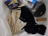 a white bag with clothing and a ruler in it