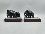 pair of black elephant bookends on wooden bases