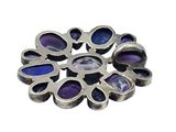 silver and amethorate broochle with purple stones on it