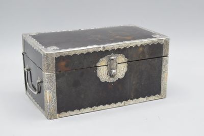 a black and silver box on a white surface