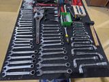 many wrenches and other tools on a table