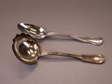 two spoons that are sitting next to each other on a table