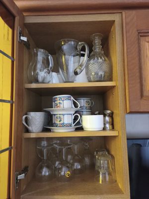 a cabinet with a lot of cups and mugs on it