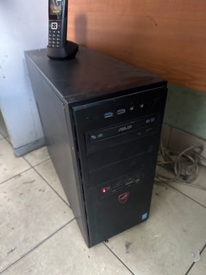 a small desktop computer sitting on top of a wooden desk
