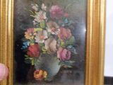 une photo d'un tableau de fleurs dans un cadre doré