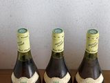 three bottles of wine sitting on top of a table next to each other