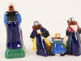 three figurines of people that are standing next to each other