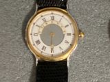 a watch that is sitting on a table next to a watch