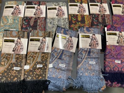 a lot of scarves that are on display on a table