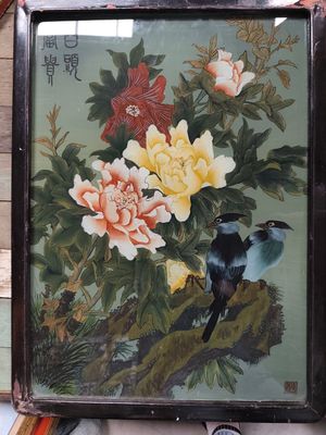 a picture of a painting of birds and flowers on display