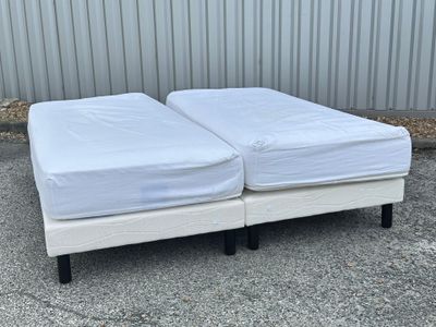 deux matelas blancs empilés l'un sur l'autre dans un parking