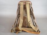 beige canvas backpack with tan leather straps on a white background