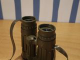 a pair of binoculars sitting on a wooden table