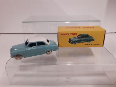 a small toy car and a box on a table